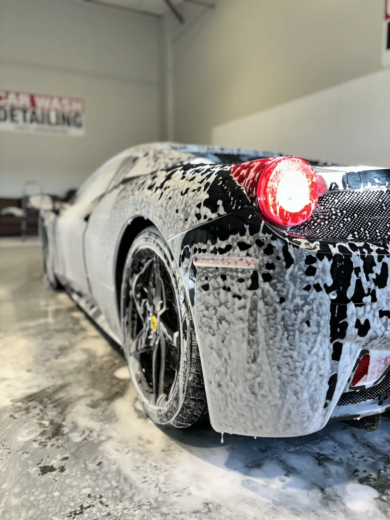 Ferrari covered in hand-wash foam during detailing